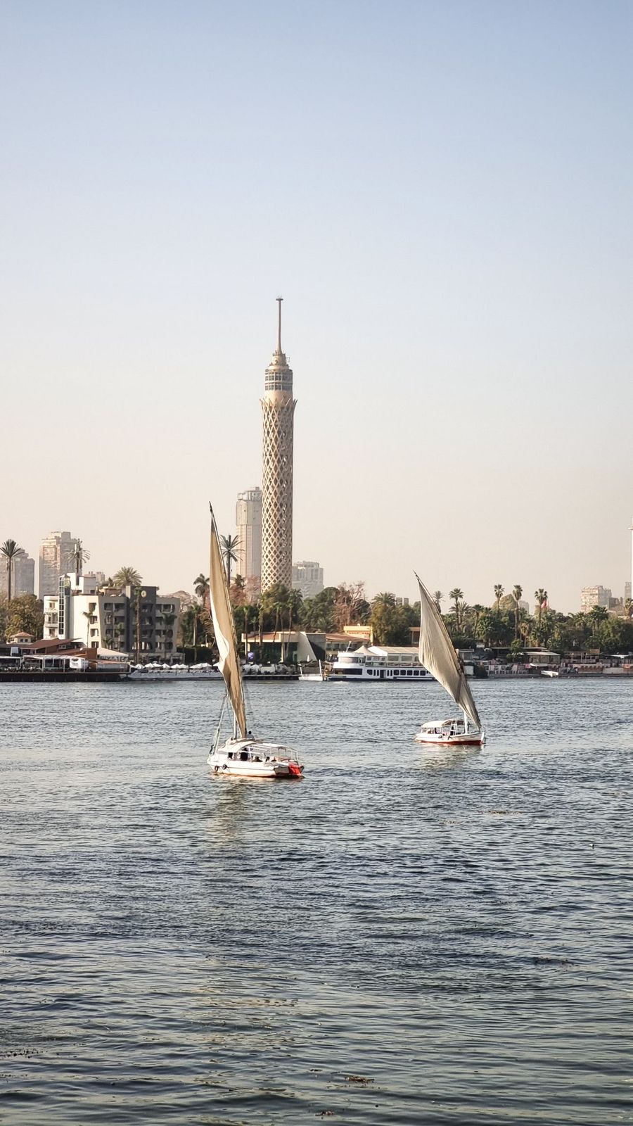 Cairo Tower and feluccas on the Nile at sunset